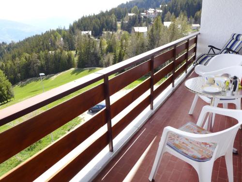 a balcony with a view of a golf course at Apartment La Clairière des Barzettes A-B-3 by Interhome in Mollens