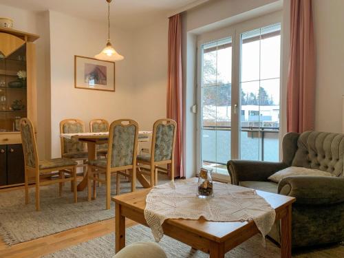 a living room with a table and a dining room at Apartment Meran-2 by Interhome in Görtschach