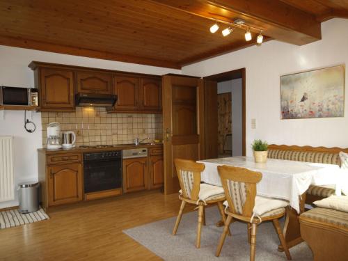 a kitchen with a table and chairs in a room at Apartment Lassnig - ARR100 by Interhome in Arriach