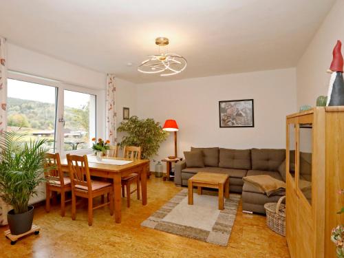 a living room with a couch and a table at Apartment Am Weinberg by Interhome in Bad Dürkheim