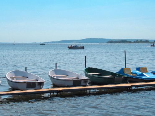 three boats sitting on a dock in the water at Apartment Seeblick by Interhome in Verchen