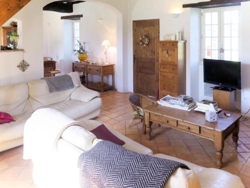 a living room with two white couches and a coffee table at Holiday Home Bouvignou - PDG301 by Interhome in Penne-dʼAgenais