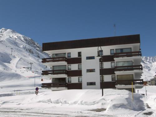 a building in the snow in front of a mountain at Apartment Les Pistes - Lavachet-2 by Interhome in Tignes
