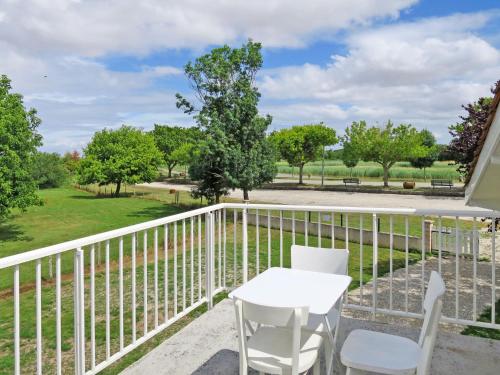 balcón con mesa y sillas y vistas a un parque en Holiday Home L'Estuaire - AQB110 by Interhome, en Bégadan