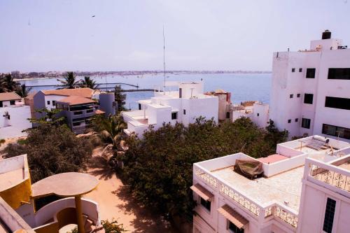 a view of a city with white buildings and the ocean at Résidence abdou diouf in Dakar