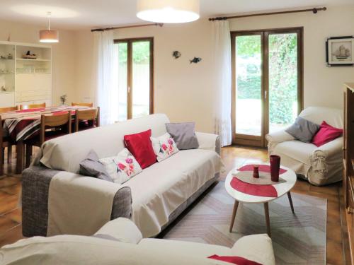 a living room with two couches and a table at Holiday Home La Rose des Sables - RES120 by Interhome in Arès