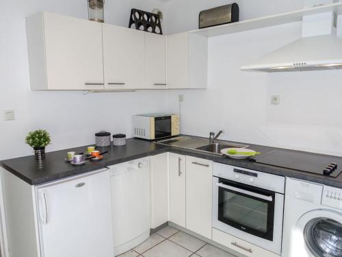a white kitchen with a sink and a dishwasher at Apartment Felicita by Interhome in Cros-de-Cagnes