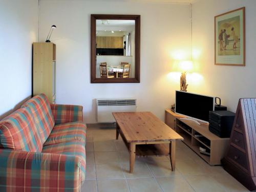 a living room with a couch and a table at Holiday Home Anne Marie by Interhome in Lacanau-Océan