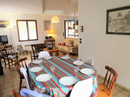 a dining room with a table and chairs at Holiday Home Caberal by Interhome in Soulac-sur-Mer