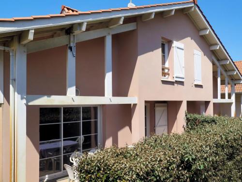 a pink house with a hedge in front of it at Holiday Home Résidence Dune Blanche - Sable - BPL322 by Interhome in Biscarrosse-Plage