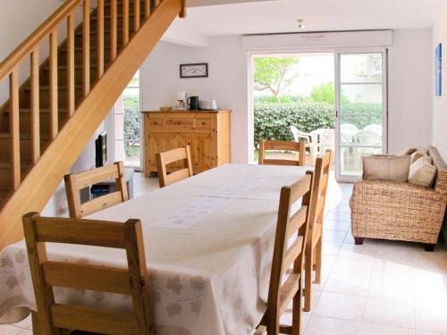 a dining room with a table and chairs at Holiday Home Résidence Dune Blanche - Sable - BPL322 by Interhome in Biscarrosse-Plage