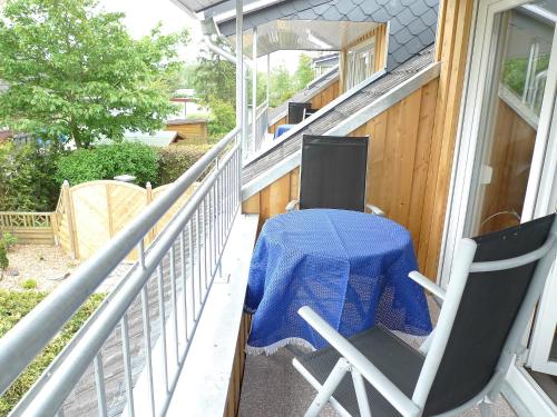 a porch with a table and chairs on a house at Apartment Dehne-2 by Interhome in Norddeich