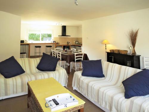 uma sala de estar com dois sofás e uma cozinha em Holiday Home Mimosa - SUL135 by Interhome em Soulac-sur-Mer