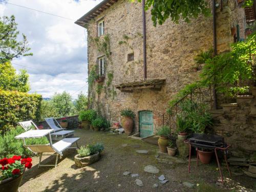 a courtyard of an old stone building with a grill at Holiday Home Casaccia by Interhome in Mommio