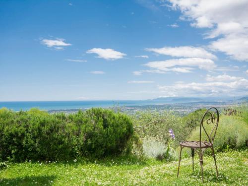 a chair sitting on top of a field of grass at Holiday Home Casaccia by Interhome in Piano di Mommio