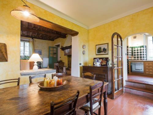 a dining room with a wooden table and chairs at Holiday Home Casaccia by Interhome in Piano di Mommio