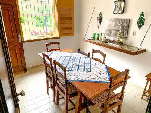 a dining room with a table and chairs and a window at Pousada Pe da Serra in Tiradentes