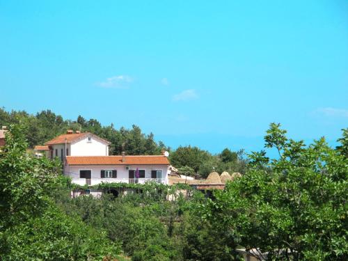 a house on top of a hill with trees at Holiday Home Mirela by Interhome in Martina