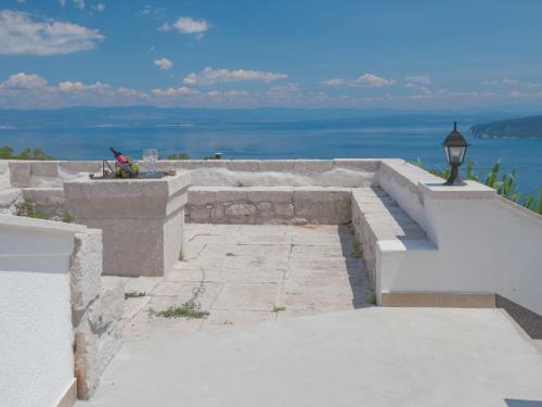 a stone staircase with a view of the water at Holiday Home San Martino I by Interhome in Mošćenička Draga