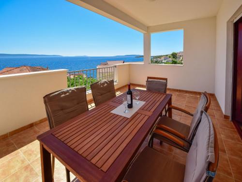 a dining room with a table and chairs on a balcony at Apartment Lucija-1 by Interhome in Trogir