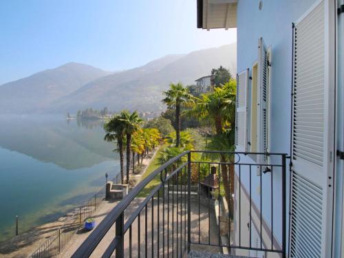 a balcony with a view of a body of water at Apartment Bosco by Interhome in Claino
