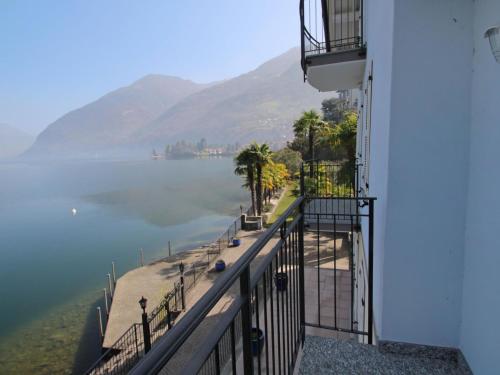 a balcony of a building with a view of the water at Apartment La Pocetta-2 by Interhome in Claino