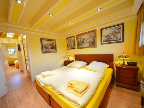 a bedroom with a large bed with towels on it at Holiday Home Dünenrose by Interhome in Groß Zicker