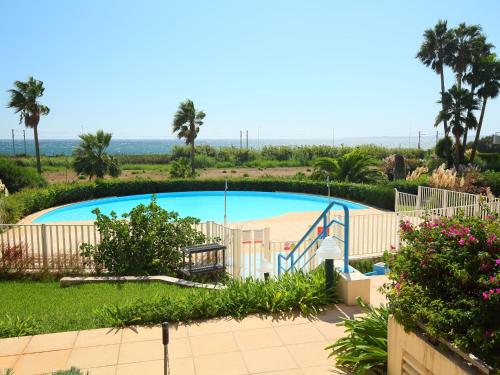 a swimming pool with a slide and a playground at Apartment Le Grand Large by Interhome in Juan-les-Pins