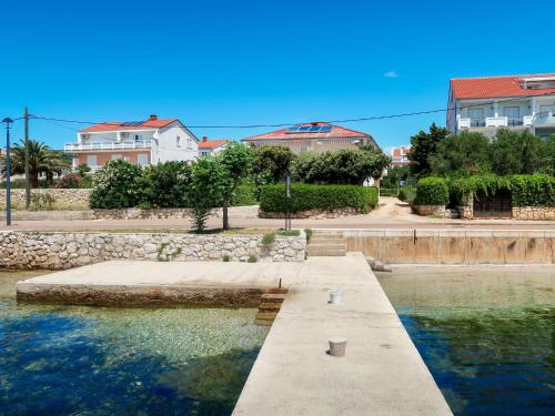 a pool of water with buildings in the background at Apartment Noa by Interhome in Rab