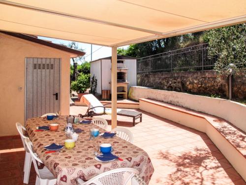 un patio con mesa y sillas bajo una sombrilla en Apartment Cristina-1 by Interhome, en Santa Lucía