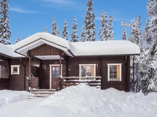 a log cabin in the snow with snow at Holiday Home Villa jaloranta b by Interhome in Ruka