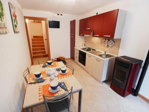 a small kitchen with a table and chairs and a stove at Holiday Home Albergo Diffuso - Cjasa Marisa by Interhome in Barcis