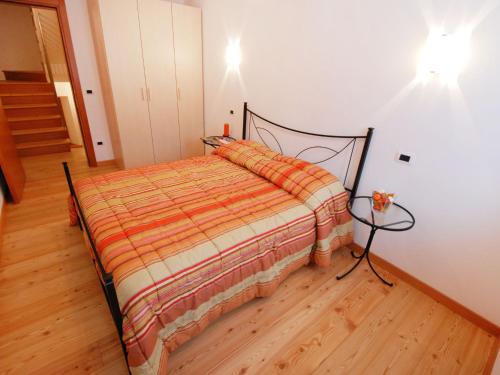 a bedroom with a bed and a wooden floor at Holiday Home Albergo Diffuso - Cjasa Marisa by Interhome in Barcis
