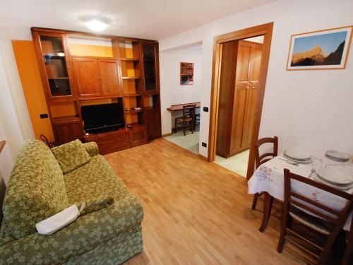 a living room with a couch and a table at Apartment Albergo Diffuso - Cjasa Fantin by Interhome in Barcis