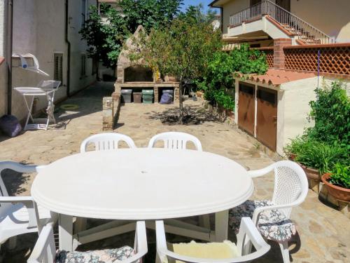 a white table and chairs on a patio at Holiday Home Lia by Interhome in La Caletta