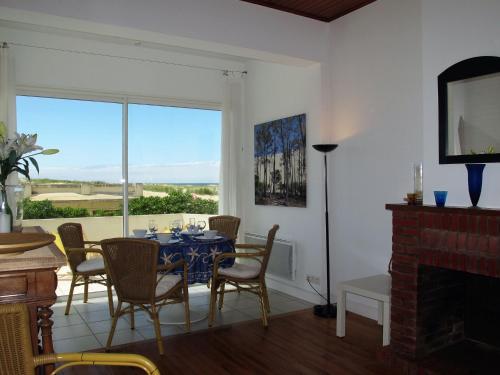 a dining room with a table and chairs and a window at Apartment Capama-1 by Interhome in Mimizan-Plage