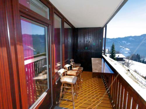 a balcony with chairs and a view of a mountain at Apartment Sonnenhang by Interhome in Grünholzer