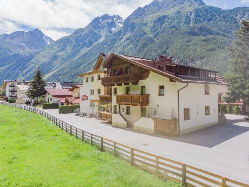 a house in the mountains with a fence at Apartment Falkner-13 by Interhome in Oberlängenfeld
