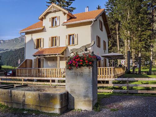 a house with a flower box in front of it at Holiday Home von Capeller by Interhome in Parpan