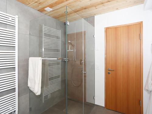 a bathroom with a shower with a glass door at Holiday Home von Capeller by Interhome in Parpan