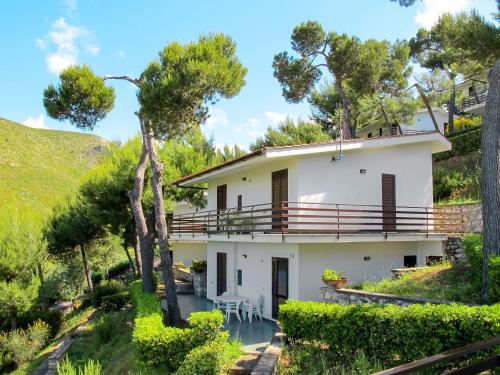 a white house with a table and chairs at Apartment Costa di Kair ed Din-6 by Interhome in Sperlonga