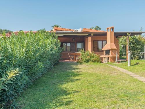 a house with a garden and a grass yard at Holiday Home Rei Mare Fronte Marina - REI205 by Interhome in Monte Nai