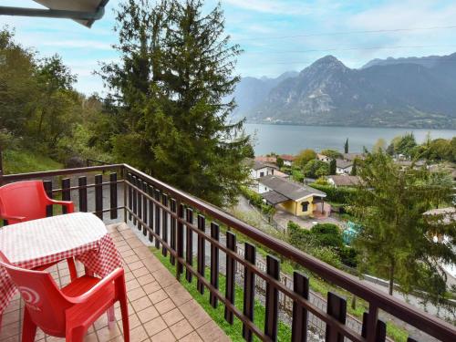 a balcony with red chairs and a view of the water at Holiday Home Villa Martinelli-3 by Interhome in Vesta