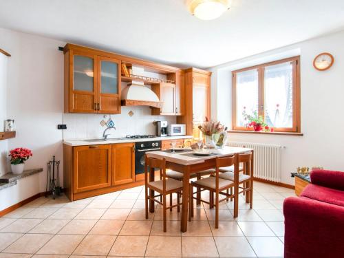 a kitchen with a table and chairs in a room at Apartment Laura - DMA320 by Interhome in Vercana