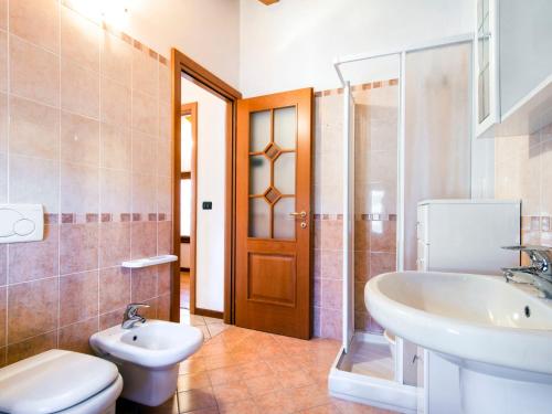 a bathroom with a sink and a toilet and a shower at Apartment Laura - DMA320 by Interhome in Vercana