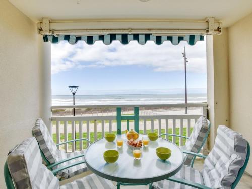 a table and chairs with a view of the beach at Apartment Grands espaces by Interhome in Mimizan-Plage