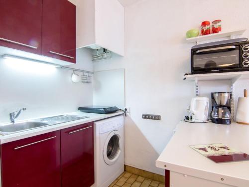 a small kitchen with a washing machine and a sink at Studio Les Floralies II-5 by Interhome in Le Grau-du-Roi