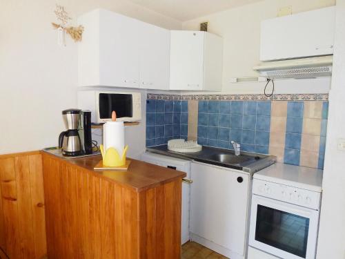 a small kitchen with a sink and a counter at Apartment Camargue Village-2 by Interhome in Le Grau-du-Roi