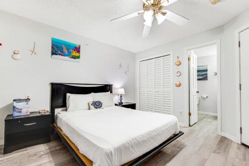 a bedroom with a bed and a ceiling fan at The Inn at St. Thomas Square #1203A in Panama City Beach