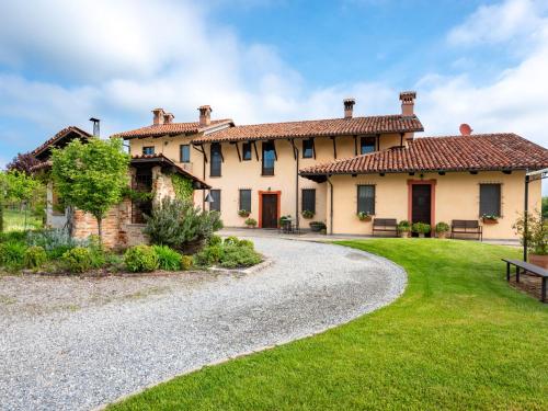 a large house with a gravel driveway at Holiday Home General Massena - NAZ111 by Interhome in Bene Vagienna